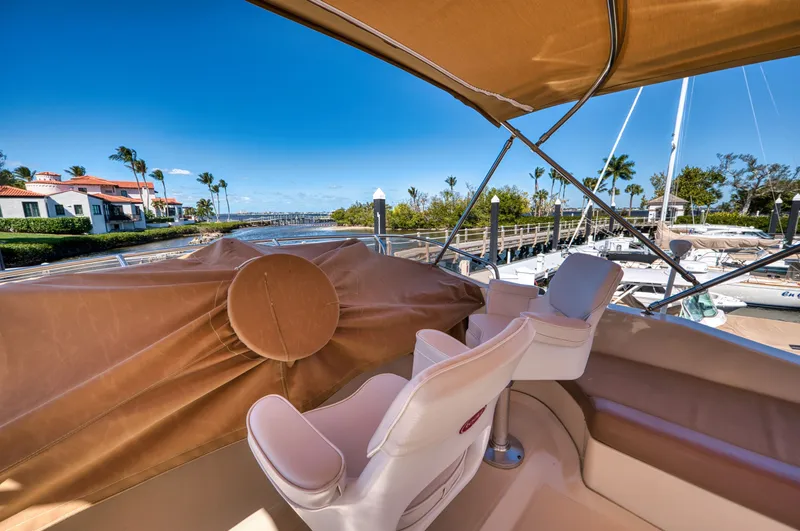 Slide: The Image of 2006 Mainship 34 Trawler with harbor view and palm trees. - 16