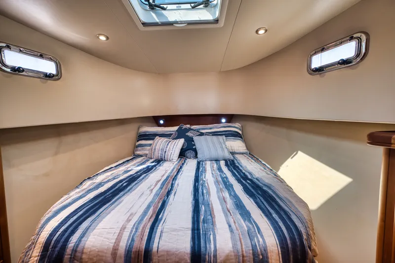 Slide: The Image of Interior of 2006 Mainship 34 Trawler with cozy bed. - 17