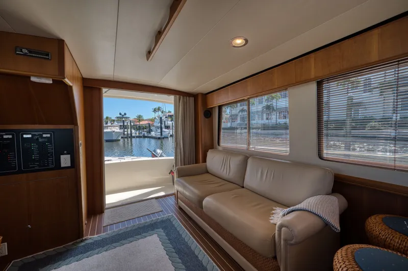 Slide: The Image of Interior of 2006 Mainship 34 Trawler with sofa and harbor view. - 22
