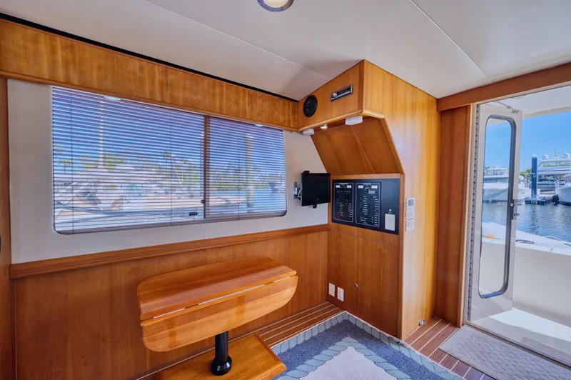 Slide: The Image of Interior of a 2006 Mainship 34 Trawler yacht with wood finish. - 23