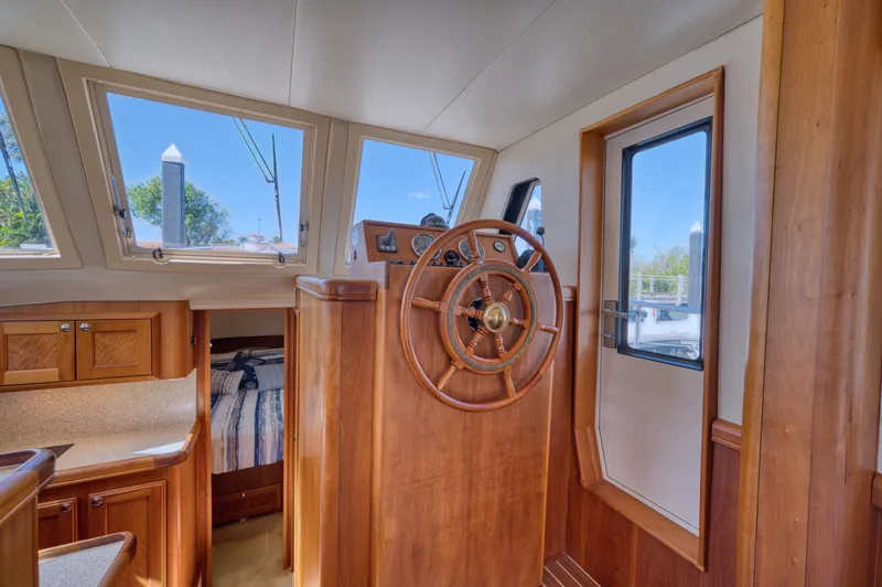 Slide: The Image of Interior of 2006 Mainship 34 Trawler with wooden helm and cabin. - 27
