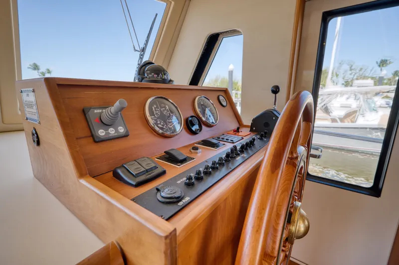 Slide: The Image of Helm of a 2006 Mainship 34 Trawler with wooden wheel. - 29