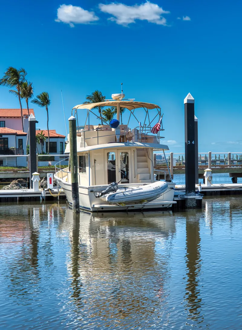 Slide: The Image of 2006 Mainship 34 Trawler docked in sunny marina. - 3