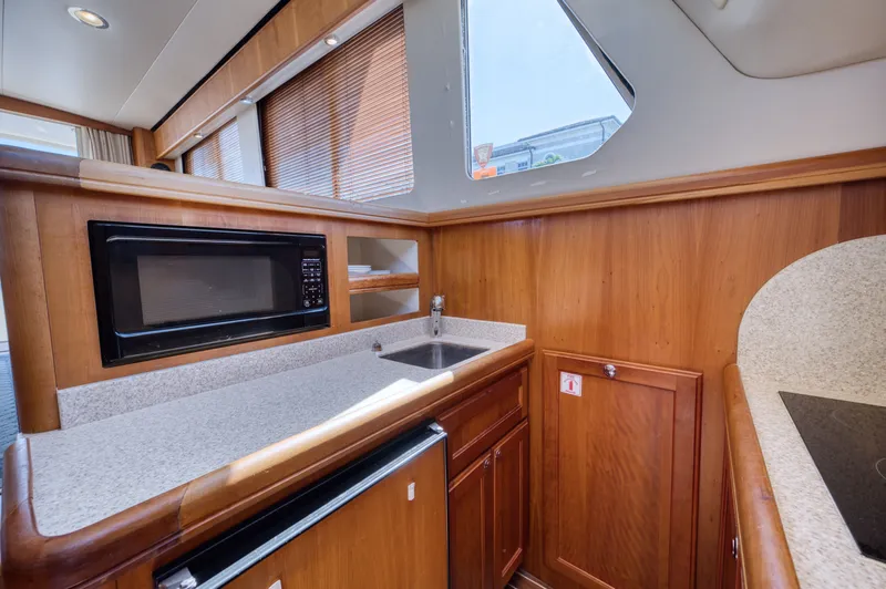 Slide: The Image of Mainship 34 Trawler 2006 kitchen area with microwave and sink. - 32