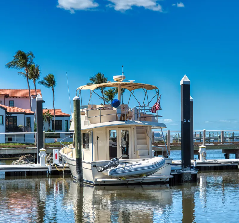 Slide: The Image of 2006 Mainship 34 Trawler docked in sunny marina. - 4