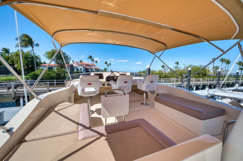 Slide: The Image of 2006 Mainship 34 Trawler with covered helm and seating area. - 40