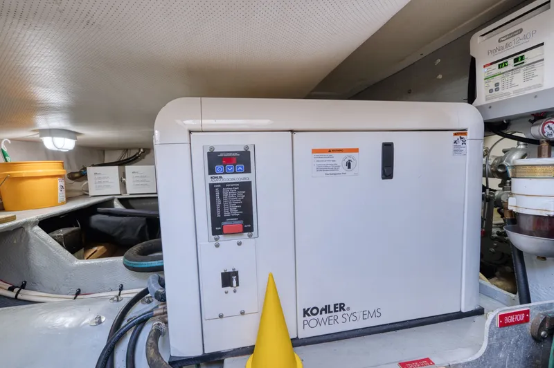 Slide: The Image of Kohler generator in the engine room of a 2006 Mainship 34 Trawler. - 45