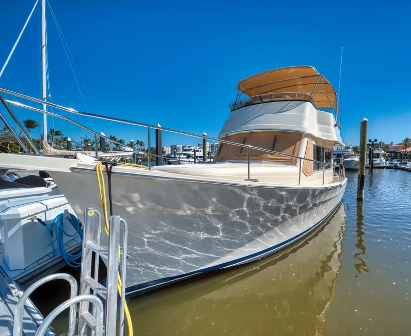 Slide: The Image of 2006 Mainship 34 Trawler docked in sunny marina. - 6