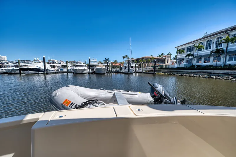Slide: The Image of Mainship 34 Trawler 2006 in harbor with dinghy, sunny day. - 9