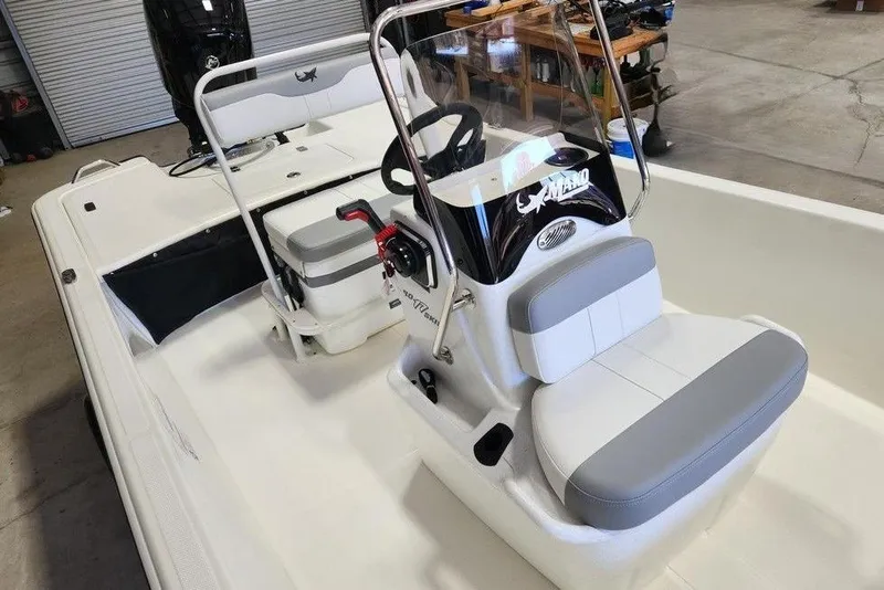 Slide: The Image of 2026 Mako Pro Skiff 17 CC boat interior with steering console and seating. - 10