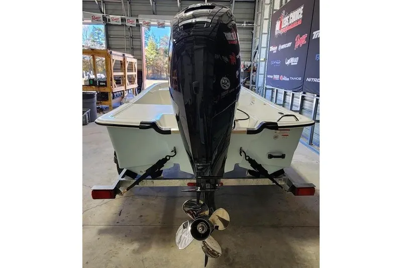 Slide: The Image of 2026 Mako Pro Skiff 17 CC boat on trailer in a garage setting. - 3