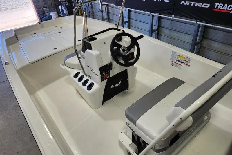 Slide: The Image of 2026 Mako Pro Skiff 17 CC boat interior with steering console and seating. - 4