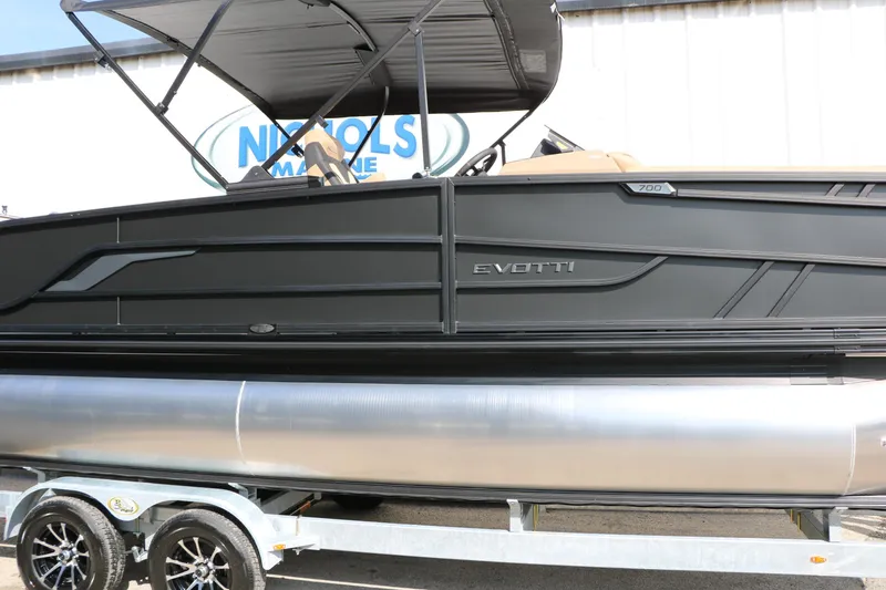 Slide: The Image of 2026 Evotti 723CS pontoon boat on trailer, sleek black design, outdoor display. - 21