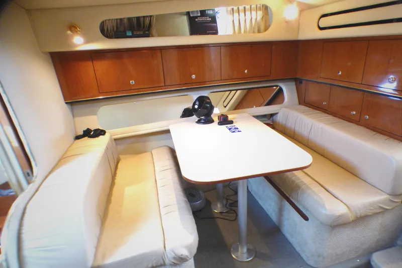 Slide: The Image of Interior of 2002 Sea Ray 340 Amberjack with cozy seating and dining table. - 11
