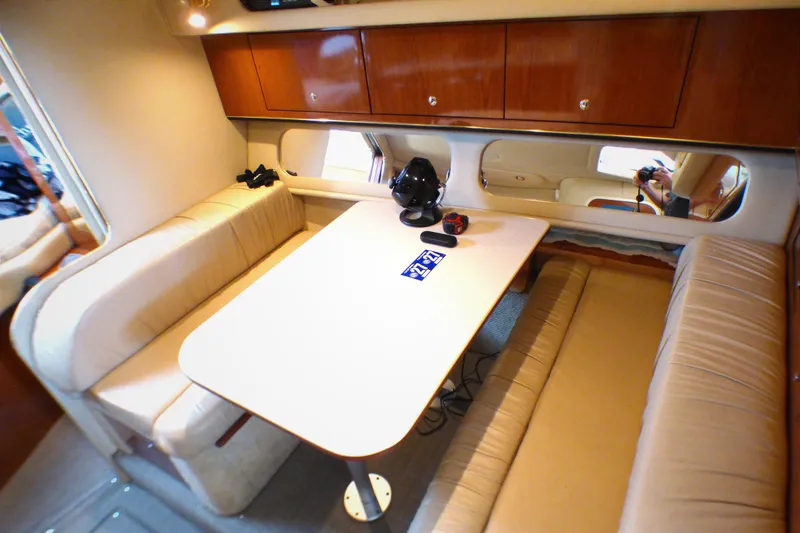 Slide: The Image of Interior of 2002 Sea Ray 340 Amberjack with cozy seating and wooden cabinetry. - 12