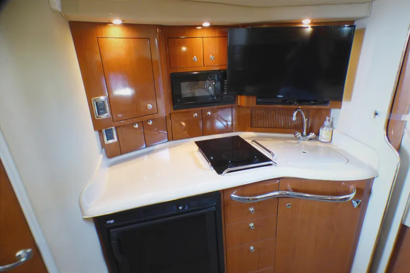 Slide: The Image of Luxurious 2002 Sea Ray 340 Amberjack yacht kitchen with modern amenities and sleek design. - 13