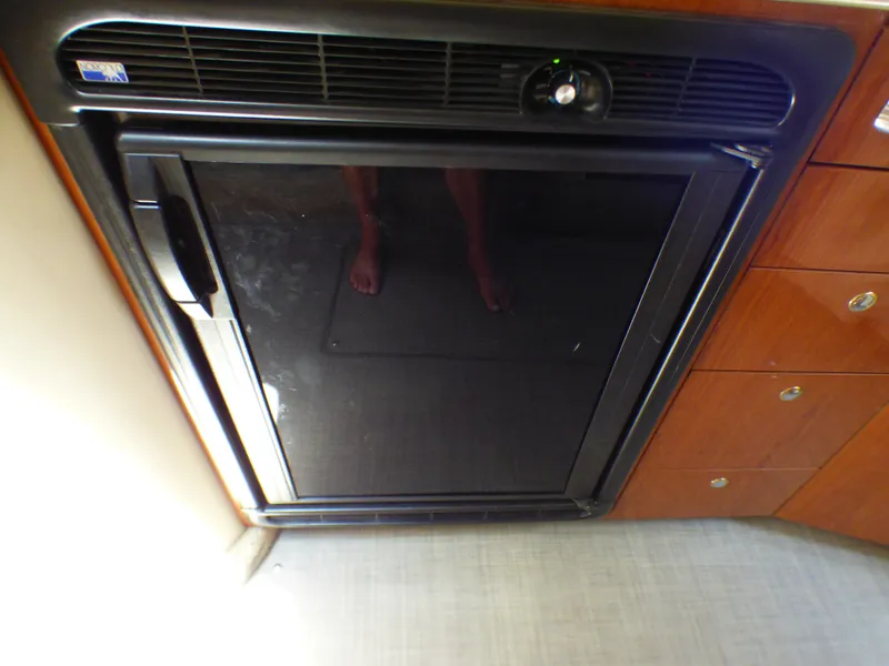 Slide: The Image of Sea Ray 340 Amberjack 2002 kitchen area with refrigerator. - 14