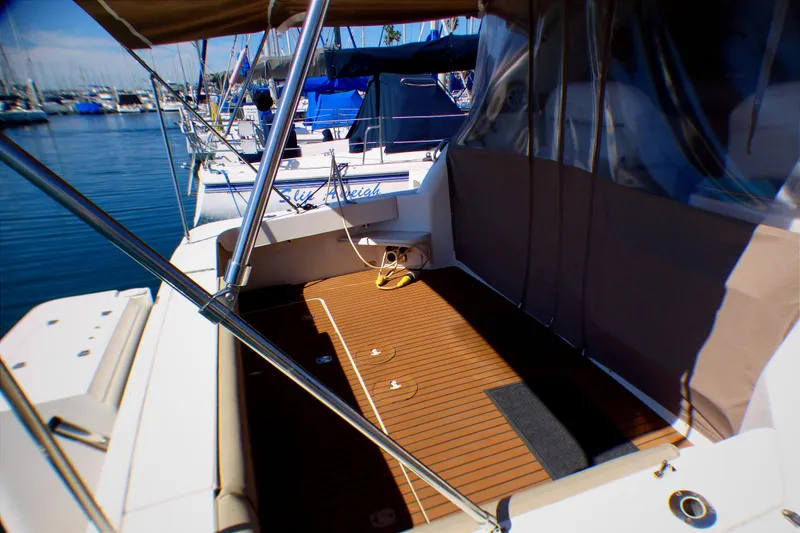 Slide: The Image of 2002 Sea Ray 340 Amberjack boat deck with canopy, docked in marina. - 33