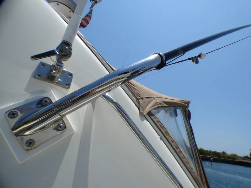 Slide: The Image of Close-up of a 2002 Sea Ray 340 Amberjack yacht with fishing rod. - 36
