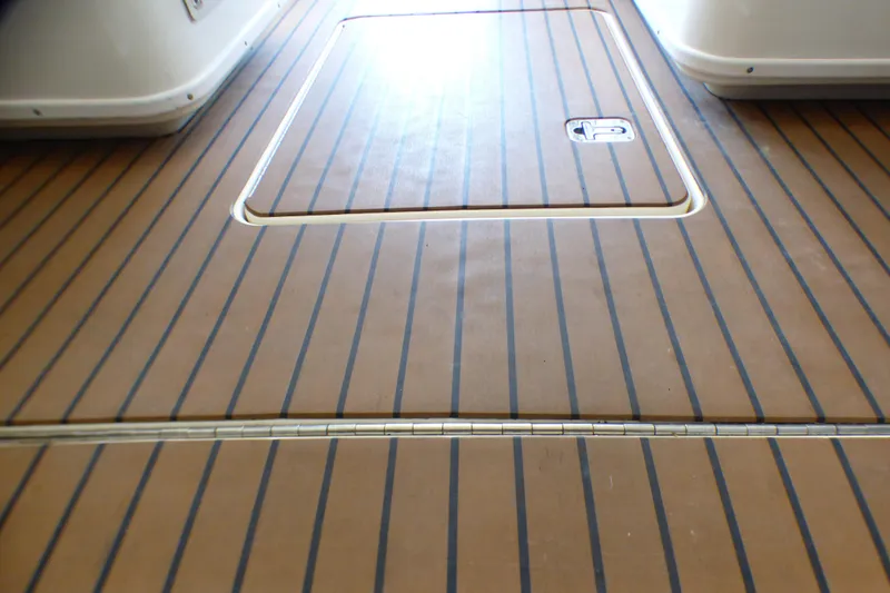 Slide: The Image of Teak deck of 2002 Sea Ray 340 Amberjack boat, featuring hatch and striped design. - 40