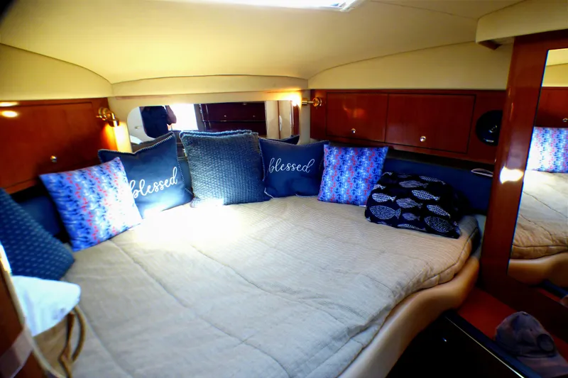 Slide: The Image of Cozy cabin interior of 2002 Sea Ray 340 Amberjack with decorative pillows. - 9