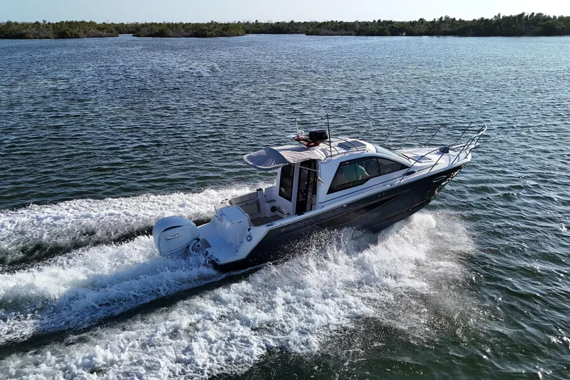 Slide: The Image of 2026 Solara S-250 Coupe cruising on open water, showcasing sleek design and performance. - 2