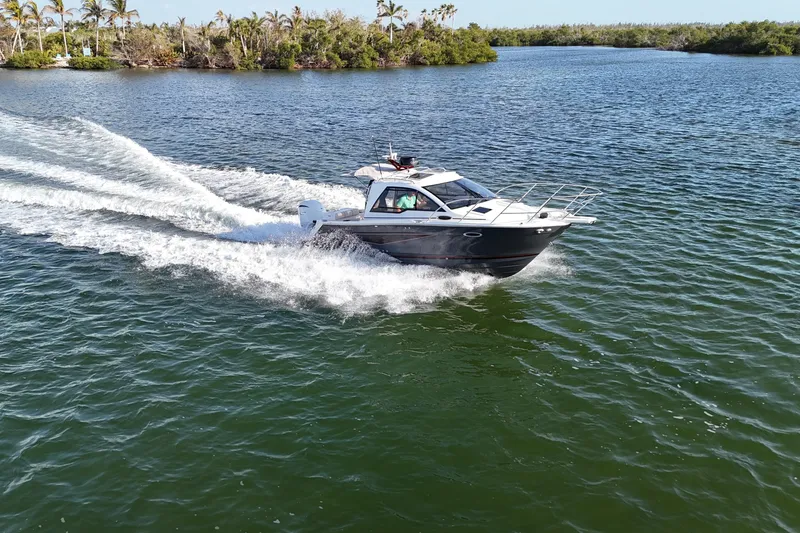 Slide: The Image of 2026 Solara S-250 Coupe cruising on a scenic lake with lush greenery. - 20