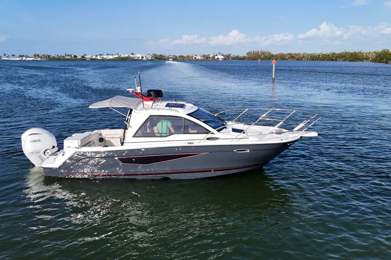 Slide: The Image of 2026 Solara S-250 Coupe boat cruising on a calm, scenic waterway. - 3
