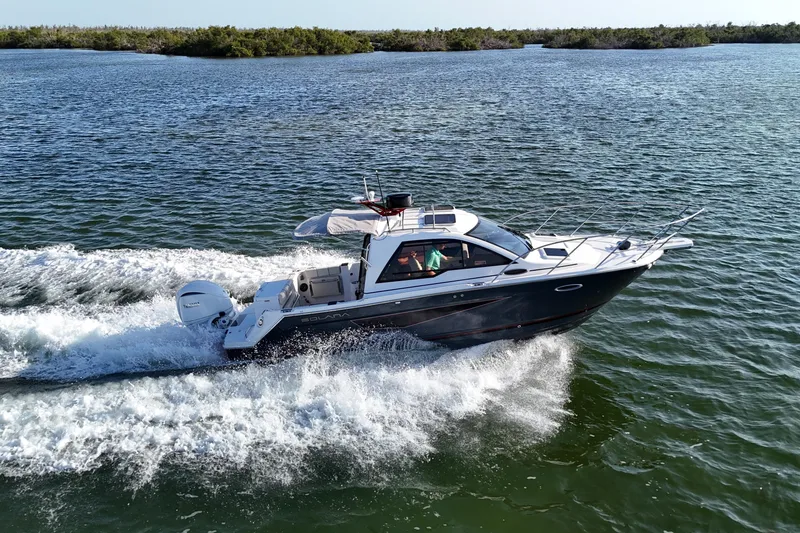 Slide: The Image of 2026 Solara S-250 Coupe cruising on open water, showcasing sleek design and performance. - 5