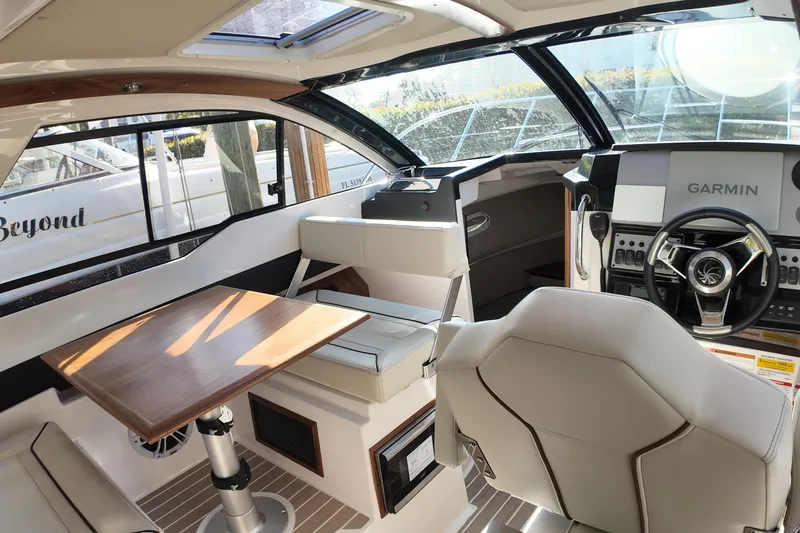 Slide: The Image of Interior of 2026 Solara S-250 Coupe boat with modern helm and seating area. - 9