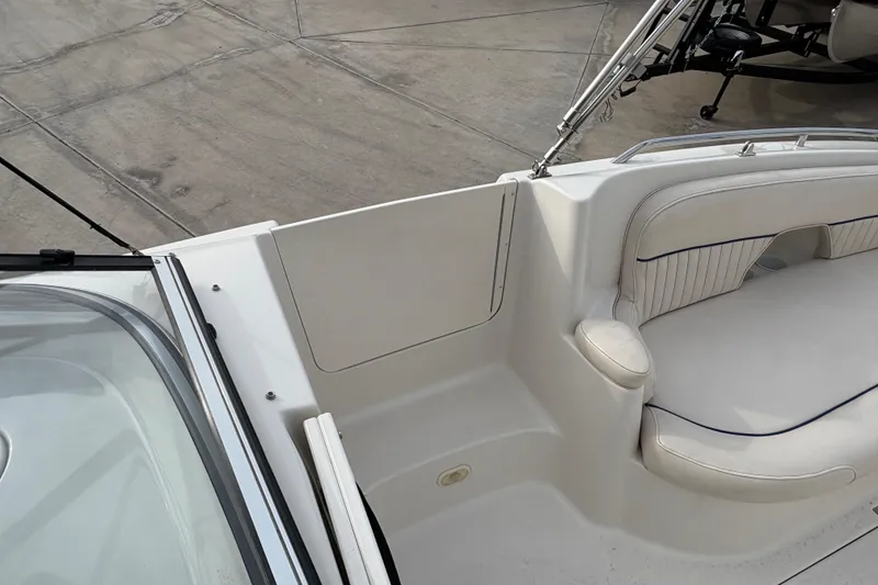 Slide: The Image of 2002 Monterey 240 Explorer Sport boat interior with white seating and deck. - 12