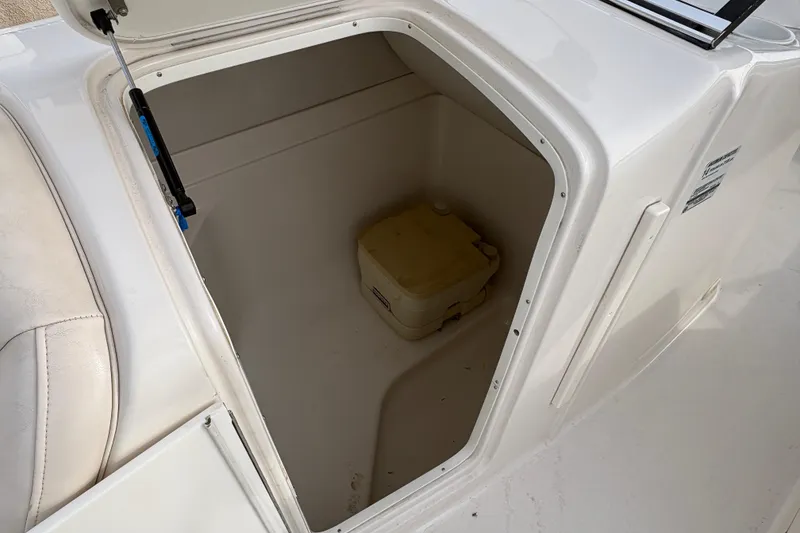 Slide: The Image of Storage compartment in 2002 Monterey 240 Explorer Sport boat with portable toilet. - 13