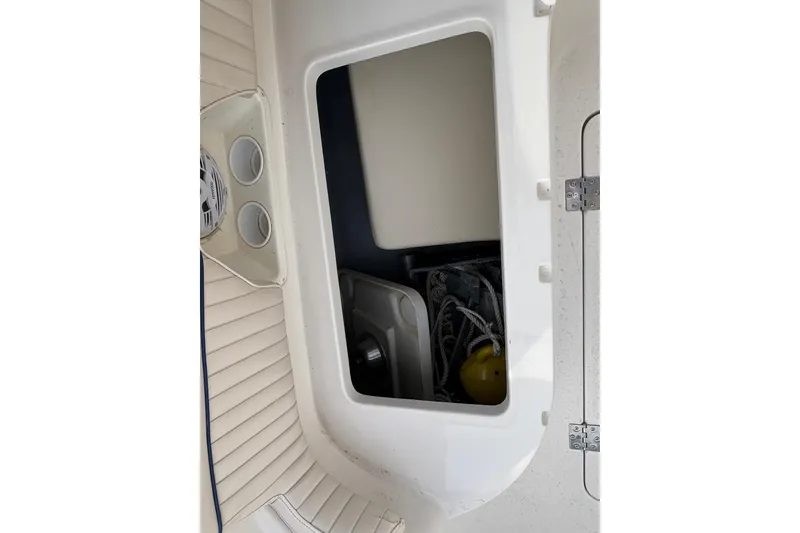 Slide: The Image of Storage compartment in a 2002 Monterey 240 Explorer Sport boat, featuring ropes and equipment. - 14