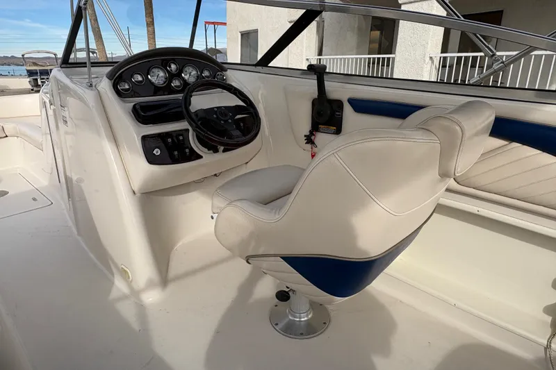 Slide: The Image of 2002 Monterey 240 Explorer Sport boat interior with steering wheel and captain's chair. - 6
