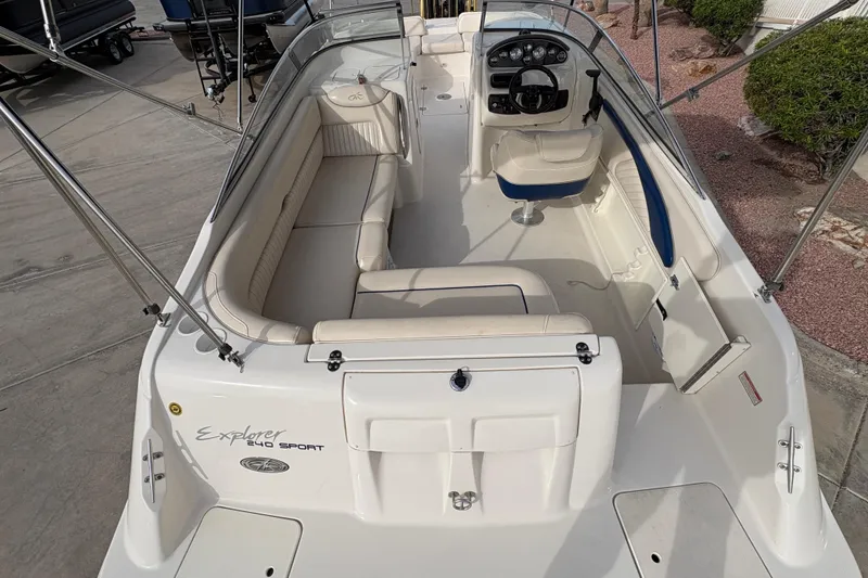 Slide: The Image of 2002 Monterey 240 Explorer Sport boat interior with seating and steering console. - 7