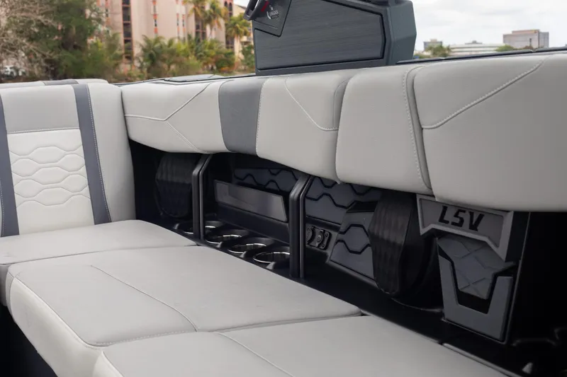 Slide: The Image of 2026 Malibu Wakesetter 23 LSV interior with sleek, modern seating and cup holders. - 12