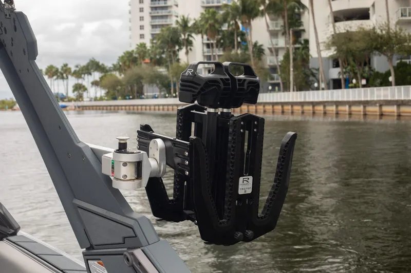 Slide: The Image of 2026 Malibu Wakesetter 23 LSV boat with advanced wakeboard rack on a scenic waterway. - 14