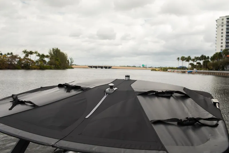 Slide: The Image of 2026 Malibu Wakesetter 23 LSV boat with cover on a calm waterway. - 16