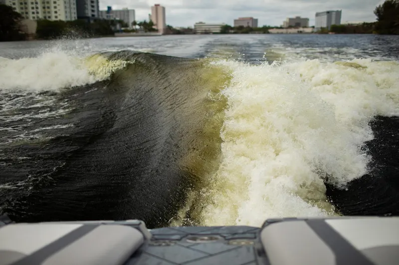 Slide: The Image of Wake created by 2026 Malibu Wakesetter 23 LSV boat on a city river. - 17