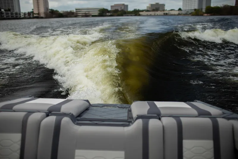 Slide: The Image of 2026 Malibu Wakesetter 23 LSV creating a wake on a city lake. - 18