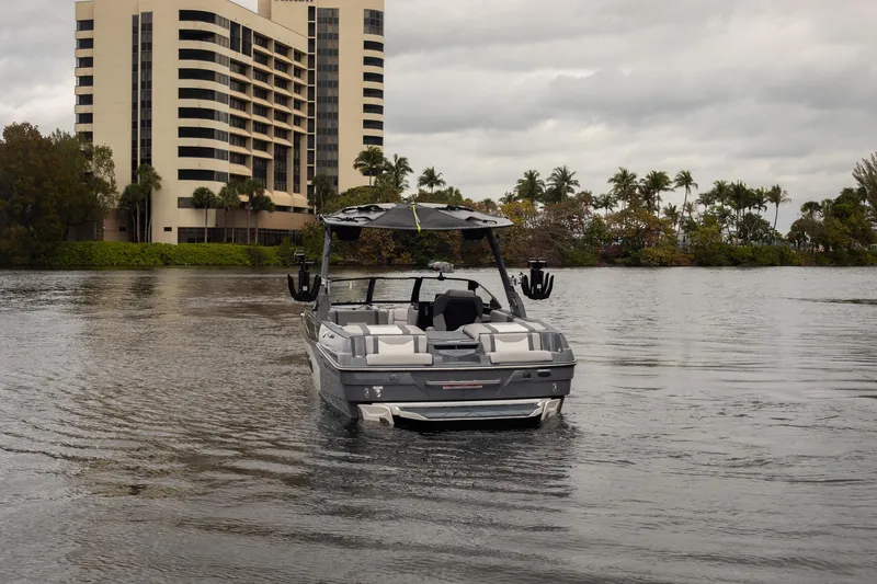 Slide: The Image of 2026 Malibu Wakesetter 23 LSV on water, with building and palm trees in background. - 4