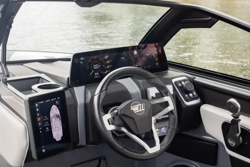 Slide: The Image of 2026 Malibu Wakesetter 23 LSV dashboard with modern digital displays and steering wheel. - 5