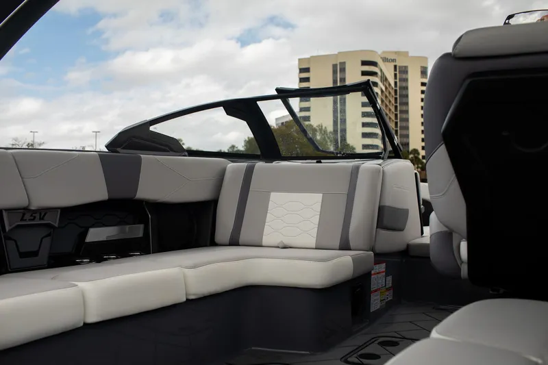 Slide: The Image of 2026 Malibu Wakesetter 23 LSV interior with modern seating and cityscape background. - 8