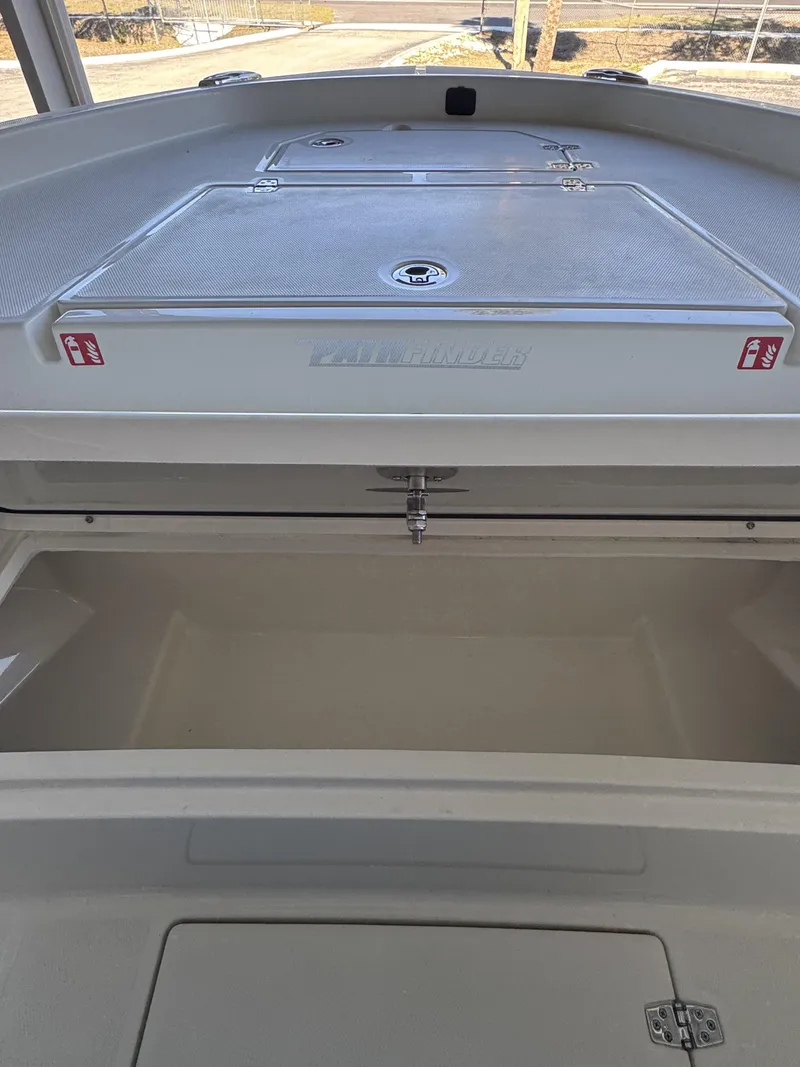 Slide: The Image of Pathfinder 2400 TRS 2026 boat storage compartment, open and spacious. - 11
