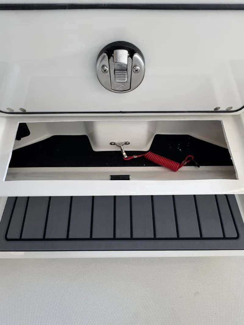 Slide: The Image of Pathfinder 2400 TRS 2026 boat compartment with red cable. - 29