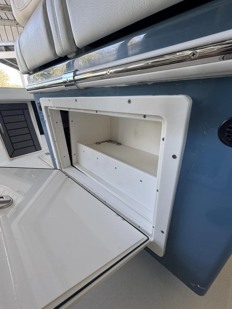 Slide: The Image of Open storage compartment on a 2026 Pathfinder 2400 TRS boat. - 34