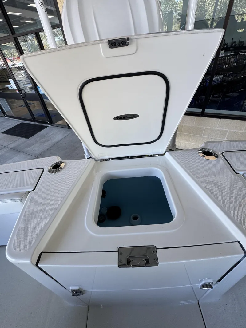 Slide: The Image of Pathfinder 2400 TRS 2026 boat with open storage compartment lid. - 44