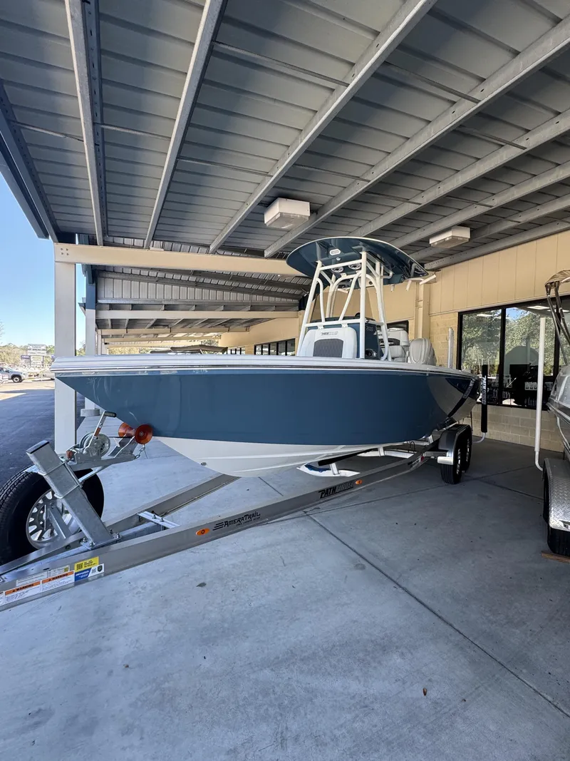 Slide: The Image of 2026 Pathfinder 2400 TRS boat on trailer under roof. - 6