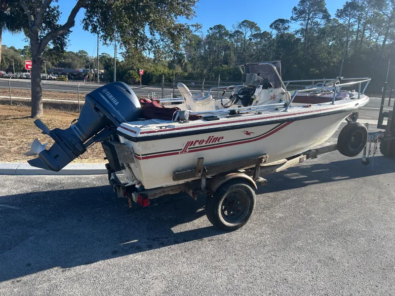 Slide: The Image of 1989 Pro-Line 16 boat with Yamaha outboard motor on trailer. - 3