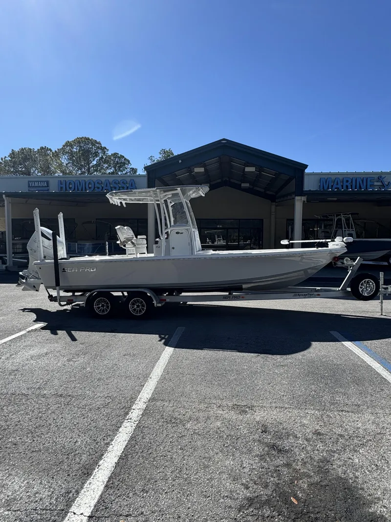 Slide: The Image of 2025 Sea Pro Bay 250 boat on trailer outside a store. - 33
